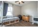 Cozy bedroom featuring a daybed with storage, ceiling fan, and natural light from the window at 17985 W Jojoba Rd, Goodyear, AZ 85338