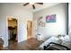 Bright bedroom with wood floors and comfortable bed and access to the walk-in closet at 17985 W Jojoba Rd, Goodyear, AZ 85338
