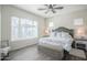 Bright bedroom featuring a large window, wood floors and neutral décor at 17985 W Jojoba Rd, Goodyear, AZ 85338