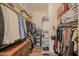 Well-organized walk-in closet featuring extensive shelving, hanging space, and dresser for organized clothing storage at 17985 W Jojoba Rd, Goodyear, AZ 85338