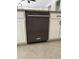 KitchenAid dishwasher with modern stainless steel finish is featured in a kitchen with tile floors at 17985 W Jojoba Rd, Goodyear, AZ 85338