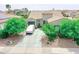 Aerial view of a charming home featuring a two-car garage and well maintained landscape at 17985 W Jojoba Rd, Goodyear, AZ 85338