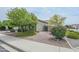 Charming front yard featuring desert landscaping, gravel, shrubs, and mature trees at 17985 W Jojoba Rd, Goodyear, AZ 85338