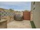 Outdoor barbecue area with a built-in grill, decorative stone wall, and access gate for convenient entertaining at 17985 W Jojoba Rd, Goodyear, AZ 85338