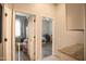 Hallway with neutral paint, featuring an open doorway into rooms with luxury vinyl flooring and light-filled windows at 17985 W Jojoba Rd, Goodyear, AZ 85338
