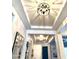 Hallway with decorative lighting, decorative mirrors and art, and a blue accent door at 17985 W Jojoba Rd, Goodyear, AZ 85338