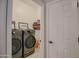 Modern laundry room with front loading washer and dryer set for convenient and efficient laundry processing at 17985 W Jojoba Rd, Goodyear, AZ 85338