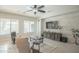 Bright living room with backyard pool view, stone accent wall, and neutral furniture at 17985 W Jojoba Rd, Goodyear, AZ 85338