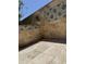 Covered outdoor patio with travertine floor and travertine walls with decorative tile at 17985 W Jojoba Rd, Goodyear, AZ 85338