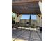 Cozy outdoor patio features a pergola with curtains and charming string lights, creating an inviting atmosphere at 17985 W Jojoba Rd, Goodyear, AZ 85338