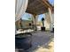Covered outdoor pergola with a dining table and an outdoor fan to keep you cool at 17985 W Jojoba Rd, Goodyear, AZ 85338