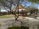 Community playground with climbing structures and shade, surrounded by lush landscaping at 17985 W Jojoba Rd, Goodyear, AZ 85338