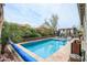 Sparkling pool surrounded by lush landscaping, a pergola, and a patio area perfect for outdoor living at 17985 W Jojoba Rd, Goodyear, AZ 85338