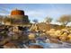 Unique stone and water feature in a desert setting with natural landscaping at 17985 W Jojoba Rd, Goodyear, AZ 85338