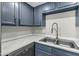 Updated kitchen featuring stylish blue cabinets, modern faucet, undermount sink, and new stainless steel dishwasher at 1828 W Tuckey Ln # 13, Phoenix, AZ 85015