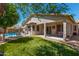 Spacious backyard with a pristine lawn, covered patio, and refreshing pool, perfect for outdoor enjoyment at 18325 W Port Au Prince Ln, Surprise, AZ 85388