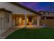 Inviting covered patio leads to the spacious backyard with lush lawn, perfect for outdoor enjoyment at 18325 W Port Au Prince Ln, Surprise, AZ 85388