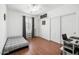 Bright bedroom features wood flooring, ceiling fan, closet and window at 18325 W Port Au Prince Ln, Surprise, AZ 85388