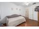 Bright bedroom features wood flooring, daybed and closet at 18325 W Port Au Prince Ln, Surprise, AZ 85388