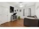 Bright bedroom features wood flooring, ceiling fan, daybed and closet at 18325 W Port Au Prince Ln, Surprise, AZ 85388