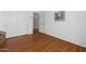 Bright bedroom features wood flooring and closet with white doors at 18325 W Port Au Prince Ln, Surprise, AZ 85388