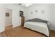 Bedroom featuring laminate floors, a ceiling fan, and a neutral sofa at 18325 W Port Au Prince Ln, Surprise, AZ 85388