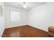 Bright bedroom features wood flooring, ceiling fan and window at 18325 W Port Au Prince Ln, Surprise, AZ 85388