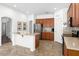 Well-lit kitchen featuring stainless steel appliances, tile flooring, and a large island for meal preparation at 18325 W Port Au Prince Ln, Surprise, AZ 85388