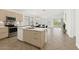 Bright kitchen with a modern island, sleek appliances, and abundant natural light from sliding glass doors at 18325 W Port Au Prince Ln, Surprise, AZ 85388