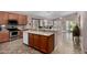 Open kitchen with stainless appliances, a stylish backsplash, and a central island with a sink at 18325 W Port Au Prince Ln, Surprise, AZ 85388
