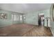 Large living room with a bay window allowing for plenty of natural light and a separate tile area for dining at 18325 W Port Au Prince Ln, Surprise, AZ 85388