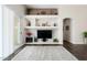Bright living room with custom shelving, fireplace, and sliding glass door for easy access to outdoor space at 18325 W Port Au Prince Ln, Surprise, AZ 85388