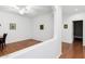 Bright living room with hardwood floors, white walls, ceiling fan, and access to other rooms at 18325 W Port Au Prince Ln, Surprise, AZ 85388
