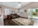 Comfortable living room with vaulted ceiling featuring plush seating and a sliding glass door to the backyard at 18325 W Port Au Prince Ln, Surprise, AZ 85388