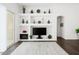 Stylish living room featuring built-in shelving, decorative fireplace, and modern decor at 18325 W Port Au Prince Ln, Surprise, AZ 85388