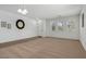 Bright living room featuring neutral carpet, white walls, and natural light from three windows at 18325 W Port Au Prince Ln, Surprise, AZ 85388