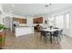 Open concept kitchen and dining area showcasing stainless steel appliances and modern design elements at 18325 W Port Au Prince Ln, Surprise, AZ 85388