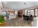 Open-concept kitchen and dining area with stainless appliances and ample seating for entertaining at 18325 W Port Au Prince Ln, Surprise, AZ 85388