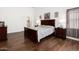 Comfortable main bedroom featuring wood floors, a bed, and matching dressers, creating a relaxing retreat at 18325 W Port Au Prince Ln, Surprise, AZ 85388