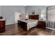 Relaxing bedroom featuring dark wood floors, a plush bed, and matching dark wood furnishings at 18325 W Port Au Prince Ln, Surprise, AZ 85388