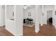 Bright office with wood-look floors and modern furniture, viewed through archways at 18325 W Port Au Prince Ln, Surprise, AZ 85388