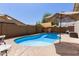 Private backyard features a sparkling pool, shade coverings and ample space for entertaining at 18325 W Port Au Prince Ln, Surprise, AZ 85388