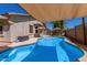 Stunning pool area featuring a shimmering pool, shaded lounge space, and inviting ambiance at 18325 W Port Au Prince Ln, Surprise, AZ 85388
