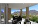Covered balcony with dining and seating area, providing shade and stunning views of the valley below at 18720 N 101St St # 3006, Scottsdale, AZ 85255