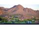 Distant view of a mountain range behind a cluster of homes at 18720 N 101St St # 3006, Scottsdale, AZ 85255