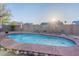 Sunlit backyard pool surrounded by desert landscaping and lounge space at 19440 N 12Th St, Phoenix, AZ 85024