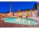 Inviting backyard pool with surrounding patio, perfect for entertaining in the evening at 19440 N 12Th St, Phoenix, AZ 85024