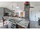 Granite-topped kitchen island with cooktop, ideal for cooking and entertaining at 19440 N 12Th St, Phoenix, AZ 85024