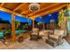 Inviting covered patio featuring comfortable seating, lush greenery, and a sparkling pool at 19440 N 12Th St, Phoenix, AZ 85024