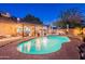 Resort-style backyard featuring a large pool, lush landscaping, and an inviting patio area at 19440 N 12Th St, Phoenix, AZ 85024